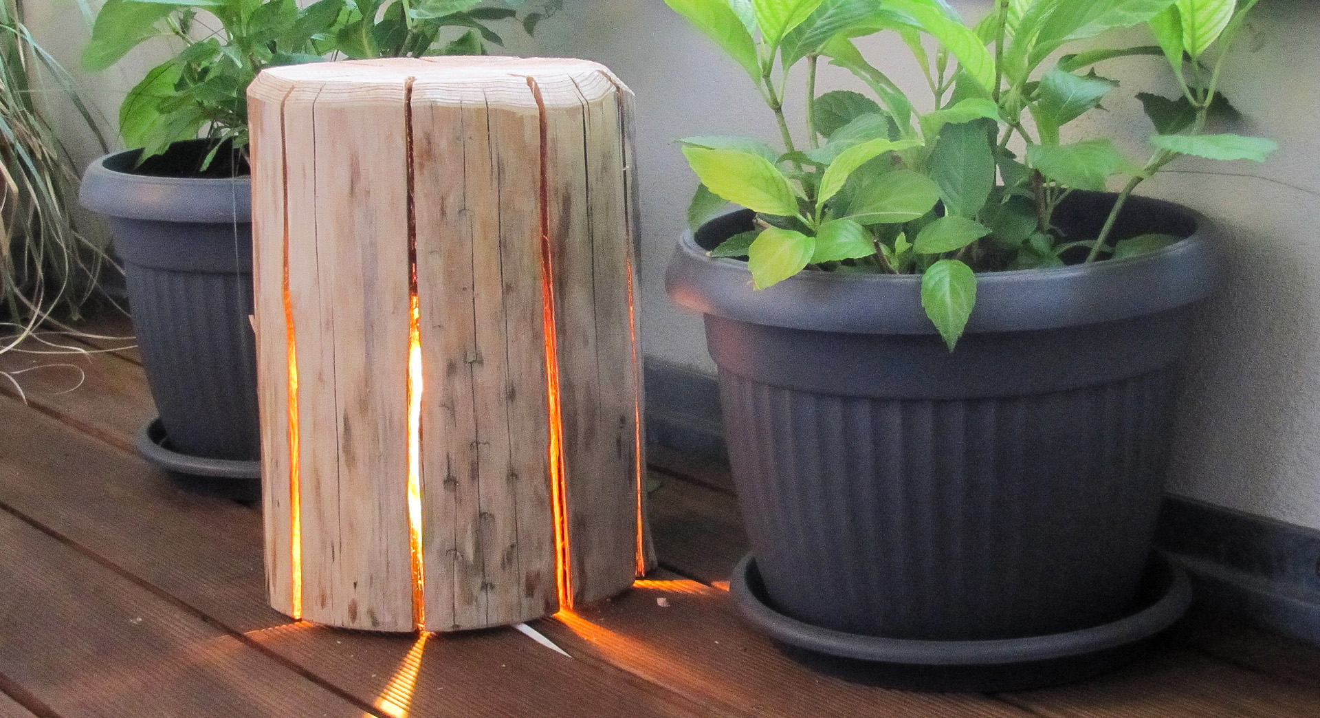 A DIY cracked log lamp with slits for the light to shine through